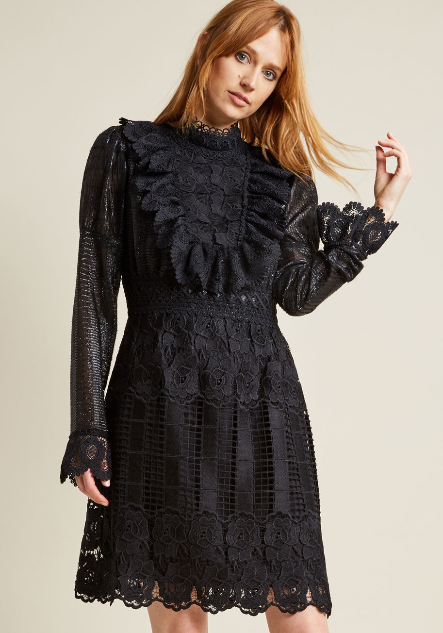 917K70 - Make yourself a conversation piece at the next get-together by styling this black lace dress from Anna Sui. Finessed with floral crocheting at its high neckline, ruffled yoke, sleeve cuffs, and A-line skirt, this mixed media dress - detailed with metallic