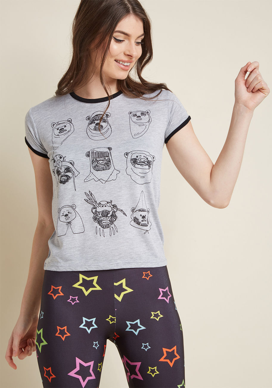 A9490ARU1 - Proclaim your passion for the many eclectic looks of Endor by sporting this adorable Star Wars tee. This heather grey ringer tee features black trim and a clan of doodle-drawn Ewoks sporting a variety of trendy headgear. Alien teddies and fashion combined