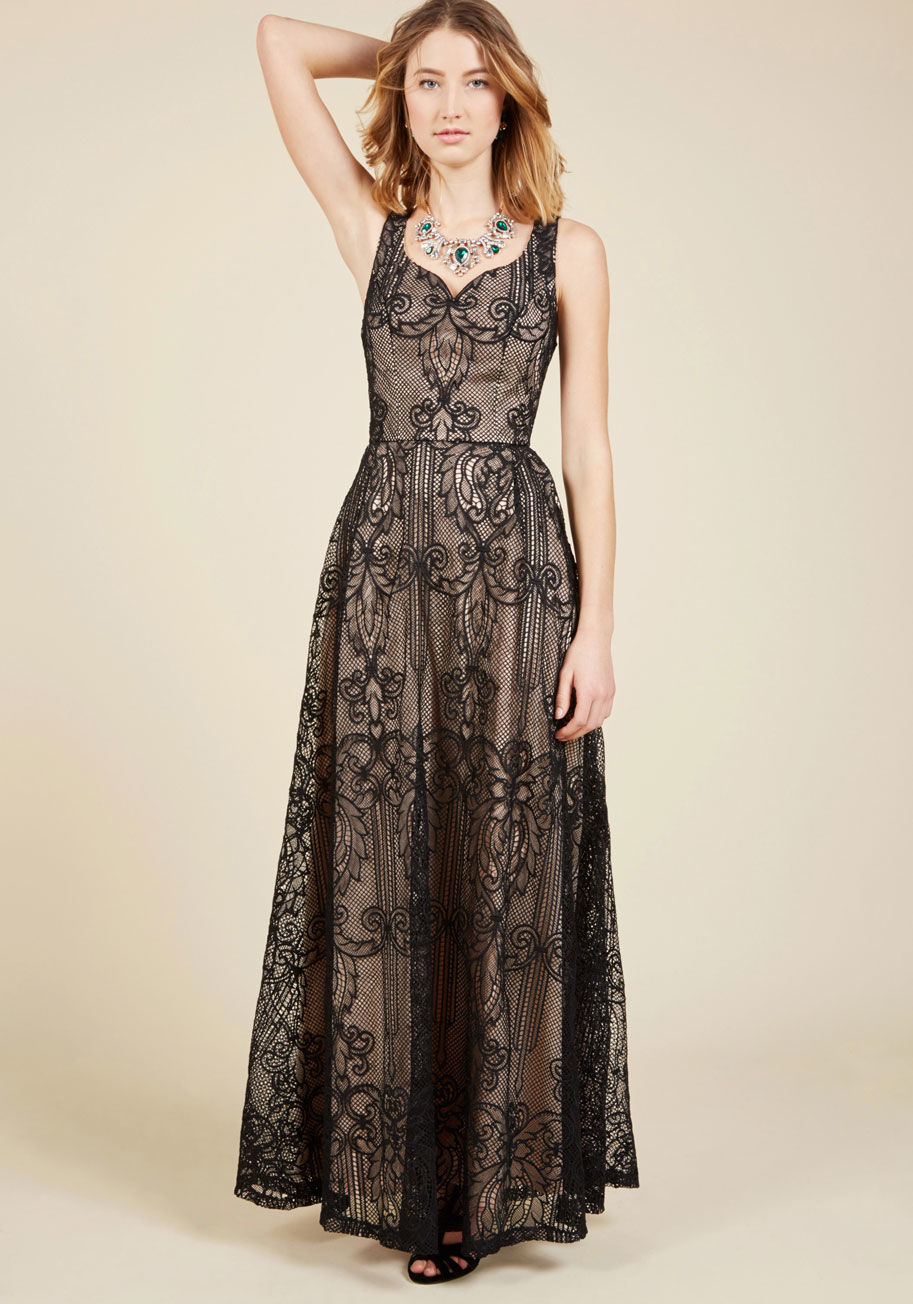 AFA561 - For your most opulent occasions, rely on this black lace maxi dress to bestow all the elegance expected - and then some! Detailed with a sophisticated notched neckline, princess seams, and a full skirt highlighted by a beige underlay, this ModCloth-exclus