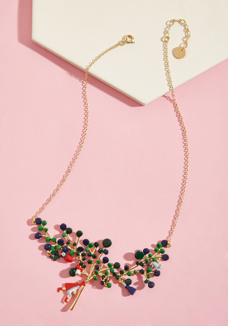 AFCR319 - Calling all wanderers to come admire your new statement necklace from French brand Les Nereides! At the end of its short gold chain, a broad tree showpiece is enhanced with blue-and-green enamel leaves, woodland-themed charms, and Little Red herself. What