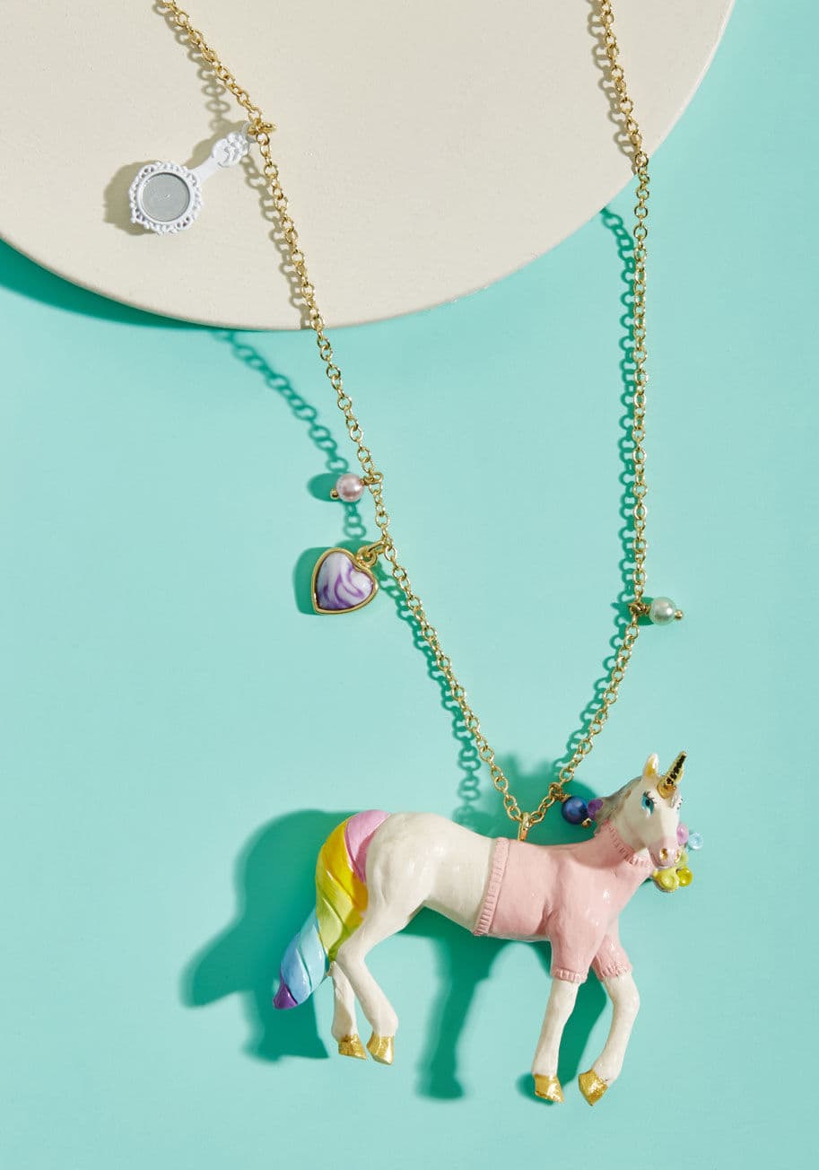 AFUN304 - The incredibly creative minds at Les Nereides dreamt up this pendant necklace to satisfy your every quirky style desire! The heart, mirror, and bead charms of this adornment's gold-plated chain lead right to a stunning, sweater-clad unicorn, complete with