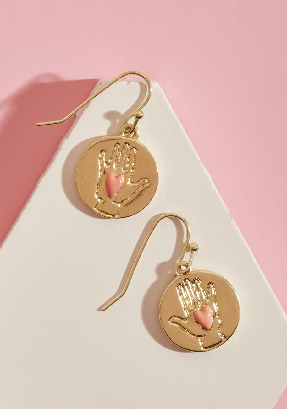 AGLM102H - Show how much love you have to give each time you don these 14k gold-plated earrings from Les Nereides. Featuring petite medallions engraved with hands holding coral enamel hearts, this pair embodies the romance and delicateness of an adoration that never