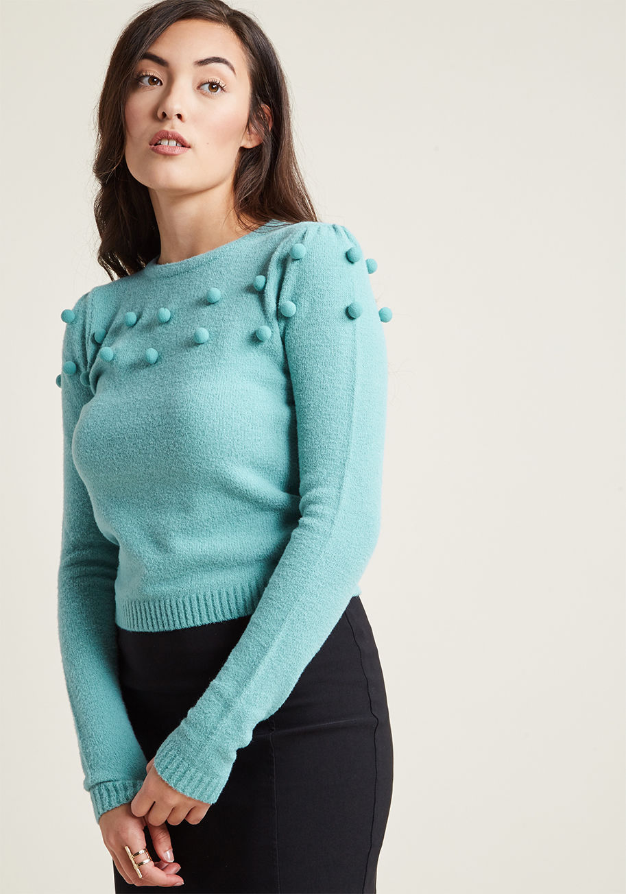 AW170103A - Make any occasion feel like a celebration with the fun-loving style of this knit sweater from Collectif! Between its robin's egg blue hue, subtly puffed shoulders, and slightly-cropped silhouette embellished with bobbles galore, this retro pullover should