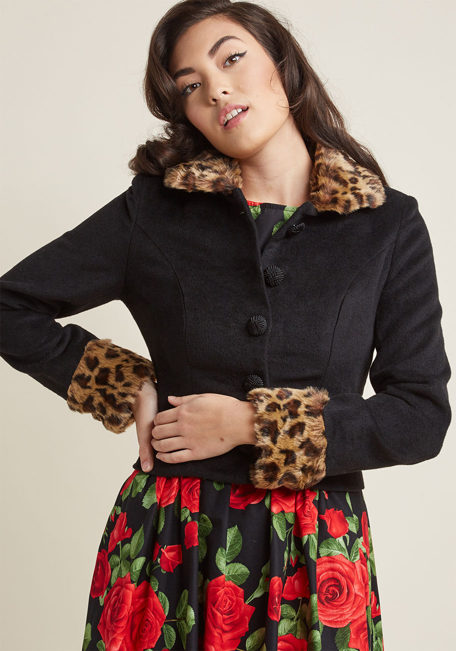 AW170609A - Layer on this black jacket from Collectif to make a noticeably nostalgic style statement! Leopard-printed faux-fur trim elevates the collar and cuffs of this cropped beauty, as crosshatch-textured buttons keep such a stunning look fastened snugly atop you