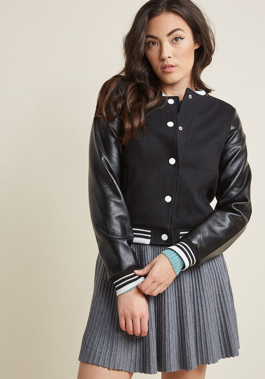 AW170611A - This black bomber jacket from Collectif serves up nostalgic style faster than you can say 'let's grab a malt!' Ideal for long drives and hand jives, this retro piece revives bygone aplomb by way of its super thick knit body, high-quality faux-leather slee