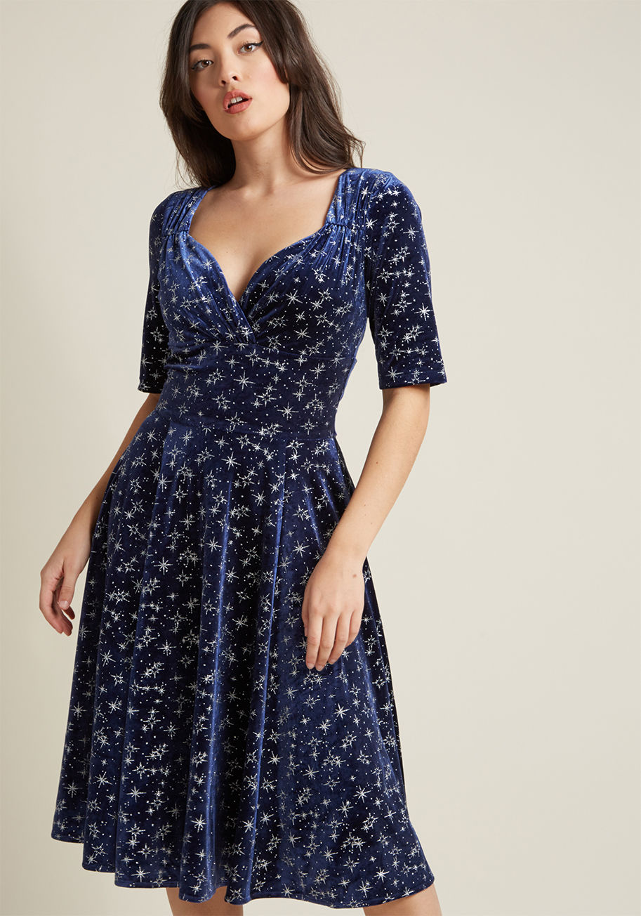 AW170810A - Your appreciation for sultry, vintage-inspired styles is the perfect pairing for this navy blue cocktail dress from Collectif! Thoughtful ruching at the neckline, half sleeves, and a twirl-worthy, midi-length skirt of this nostalgic frock create the sophi