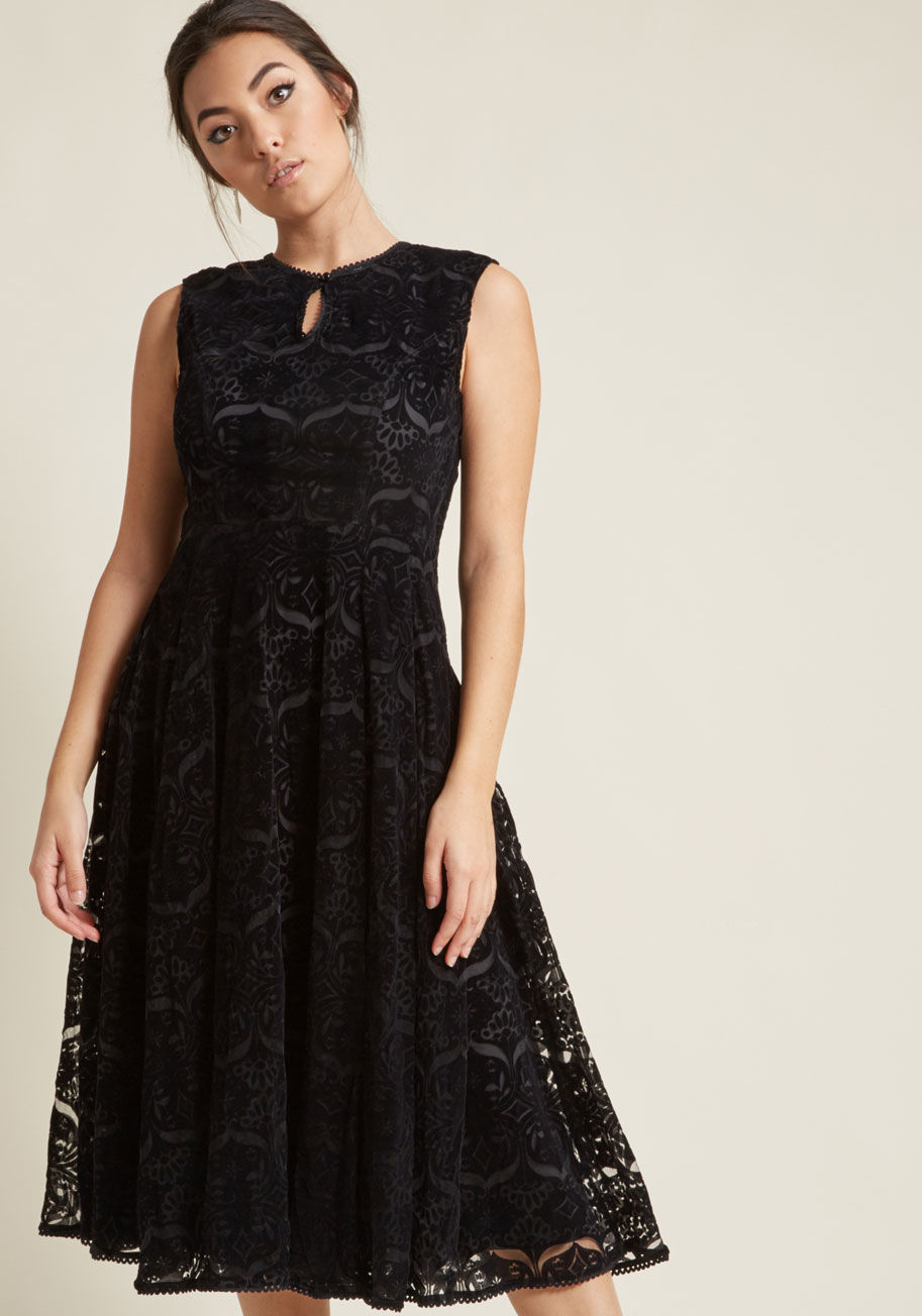 BBAW170802A - Keep your ensemble following engaged by switching things up with showstopping styles like this black velvet midi dress! Undeniably nostalgic, this fit and flare exemplifies allure with its floral damask burnout, looped trim around the neckline and front k