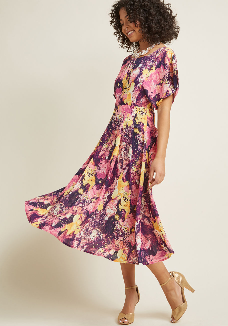 BBSS180801B - If the bright pattern of this brilliant midi dress inspires anything, it's optimism and allure! Designed with painterly purple, fuchsia, rose, and yellow speckles 'n' swirls, a kimono-inspired bodice featuring cuffed short sleeves, and an accent-pleated s