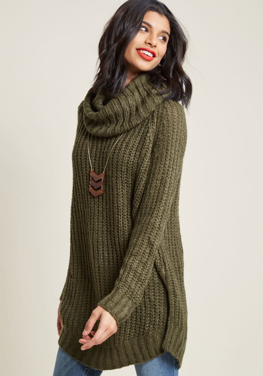 C7354 - A return trip to your northern roots is the perfect opportunity to debut this dark olive sweater. Meeting with old pals, classmates, and family is made all the better with the cozy cowl neck, vented sides, and oversized fit of this essential, lightweight 