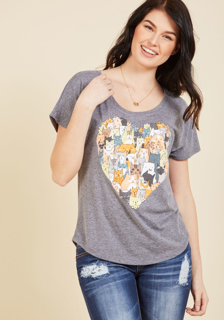 Cat Love - There's an endless array of ways we could express our affection toward this grey T-shirt, but for the sake of characters, we'll keep it brief! Just peep the ModCloth-exclusive print of a heart-shaped gang comprised of kitties galore, and you'll be gushing