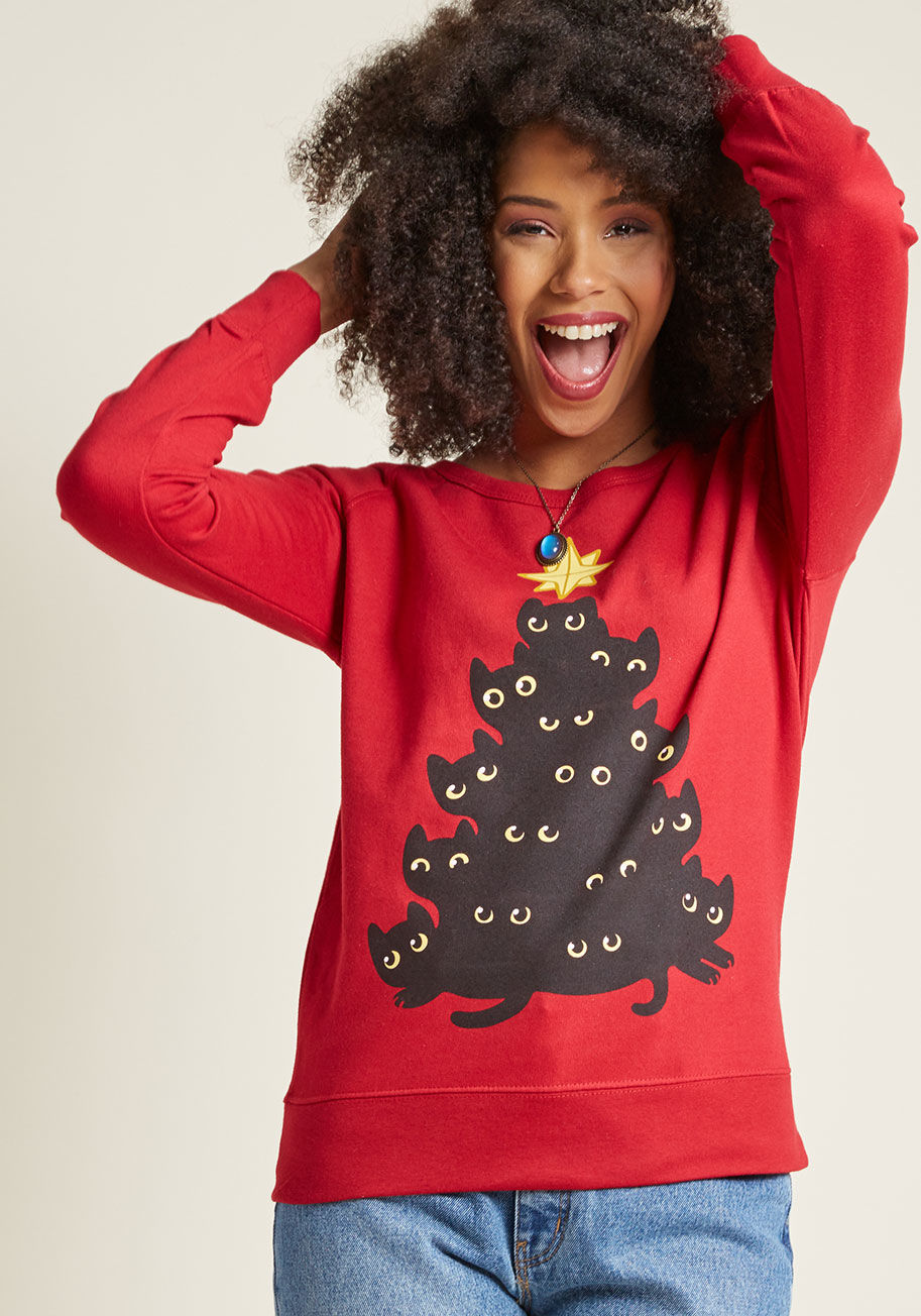 Cat Tree Sweatshirt - There's a stack-up of festive felines on this red pullover, and they've got a sweet message for you - have a purr-worthy holiday! All snuggled together under a golden star, this merry bunch will have you pouncing on the spirit of this season.