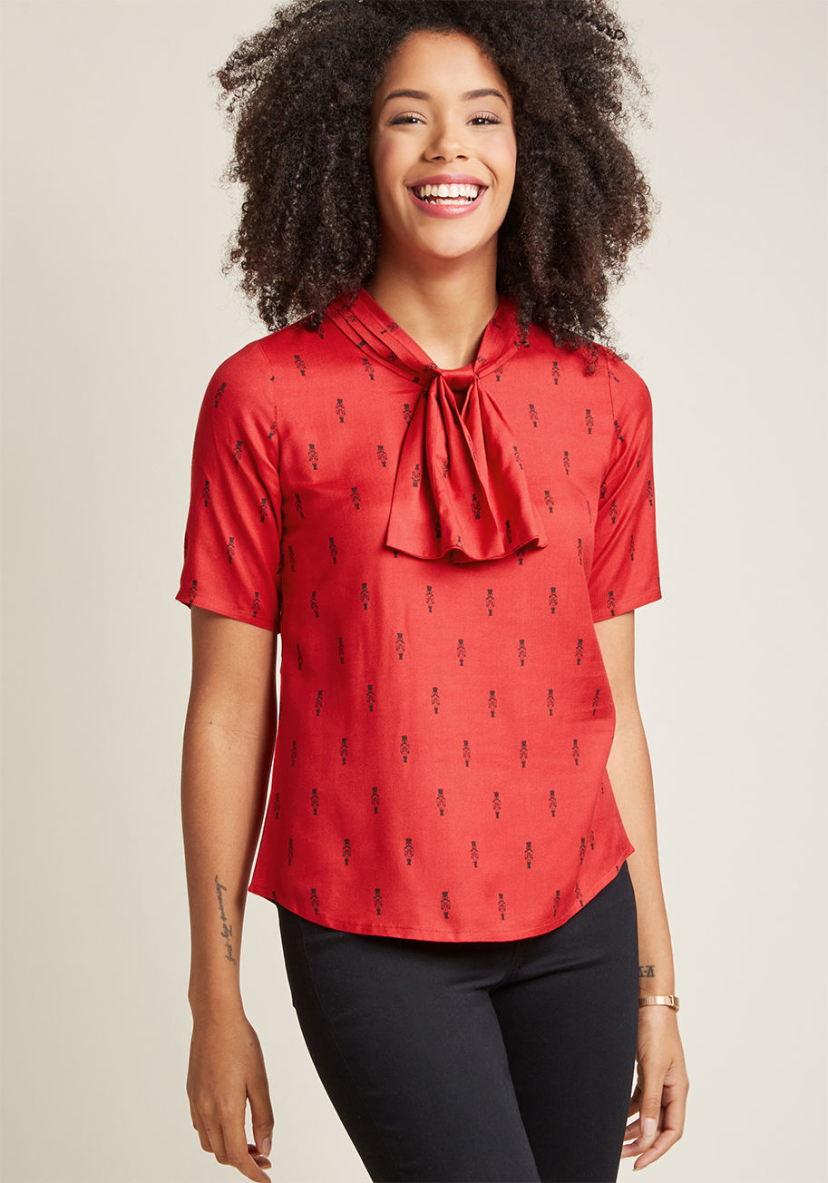 CB007B - You love a polished top with a hint of something special, so we're certain you'll adore this bright red blouse! The knotted neckline detail and half sleeves of this work-ready piece make it perfect for the office, while its ModCloth-exclusive pattern of b