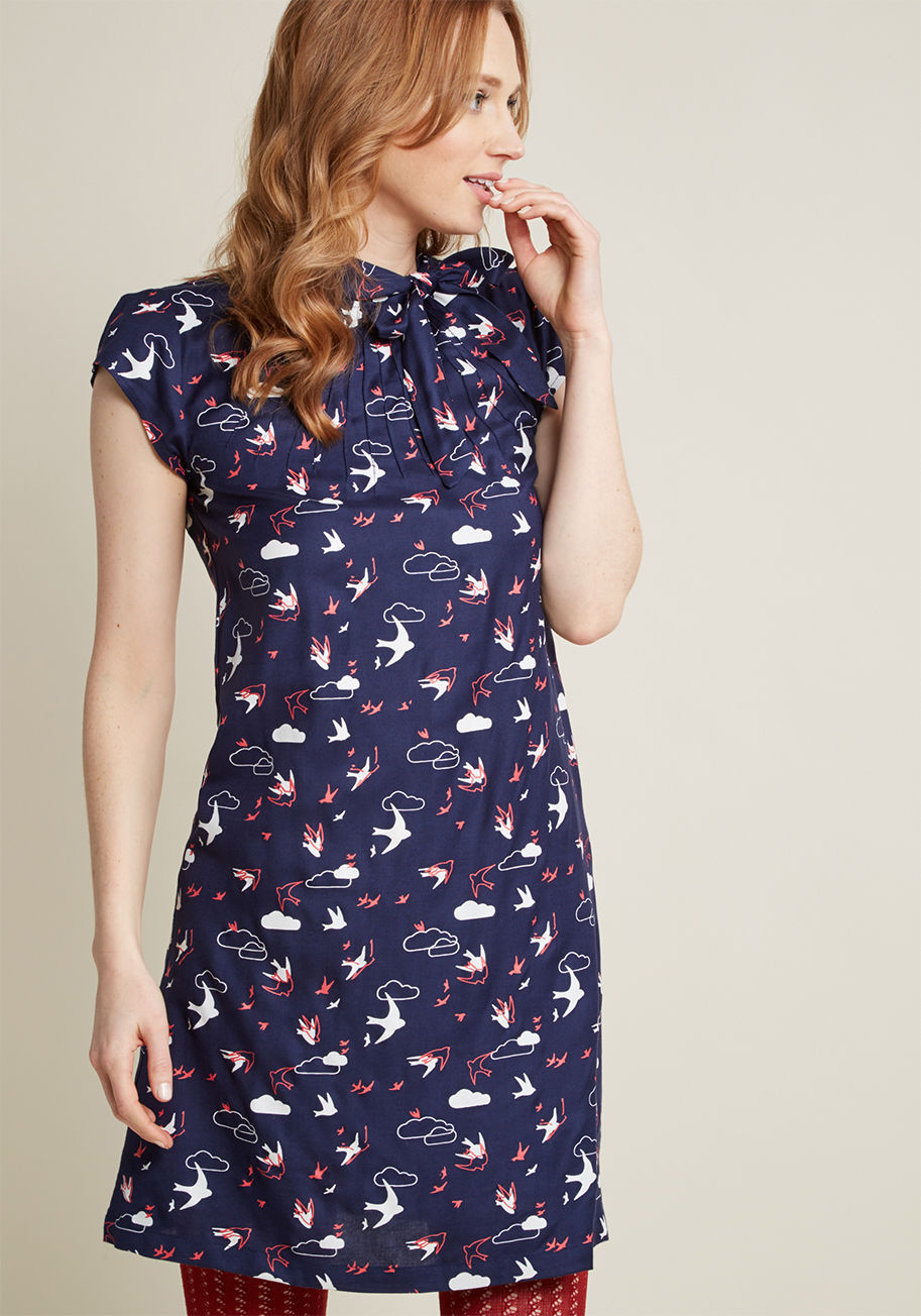 CD403-SW/CL-NAVY - It&rsquo;s a bird! It&rsquo;s a plane! No, it&rsquo;s the lofty and lovely feeling inspired by this cotton dress! A ModCloth-exclusive pattern of red and white swallows soar past the clouds printed on this navy shift, while a neck tie and pintucking eleva