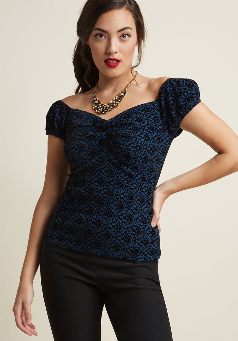 CVAW160405A - You&rsquo;re pleased as punch over this off-the-shoulder top and you want to party about it! Style the navy blue hue, black smocking, neckline pleating, and decorative buttons of this Collectif top with a daytime look and post up