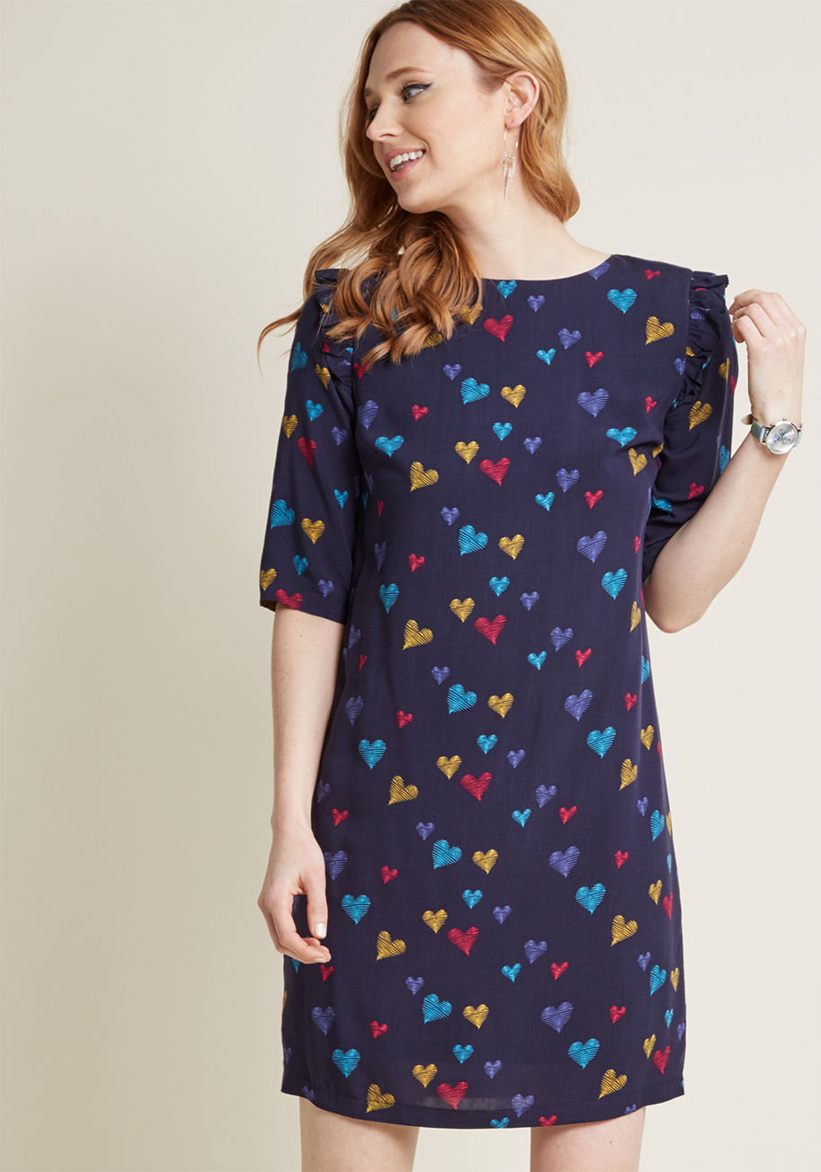 D0147 - Always true to your lighthearted style, you're quick to add this navy blue shift dress by Sugarhill Boutique to your collection of quirky frocks. The scribbled hearts colored