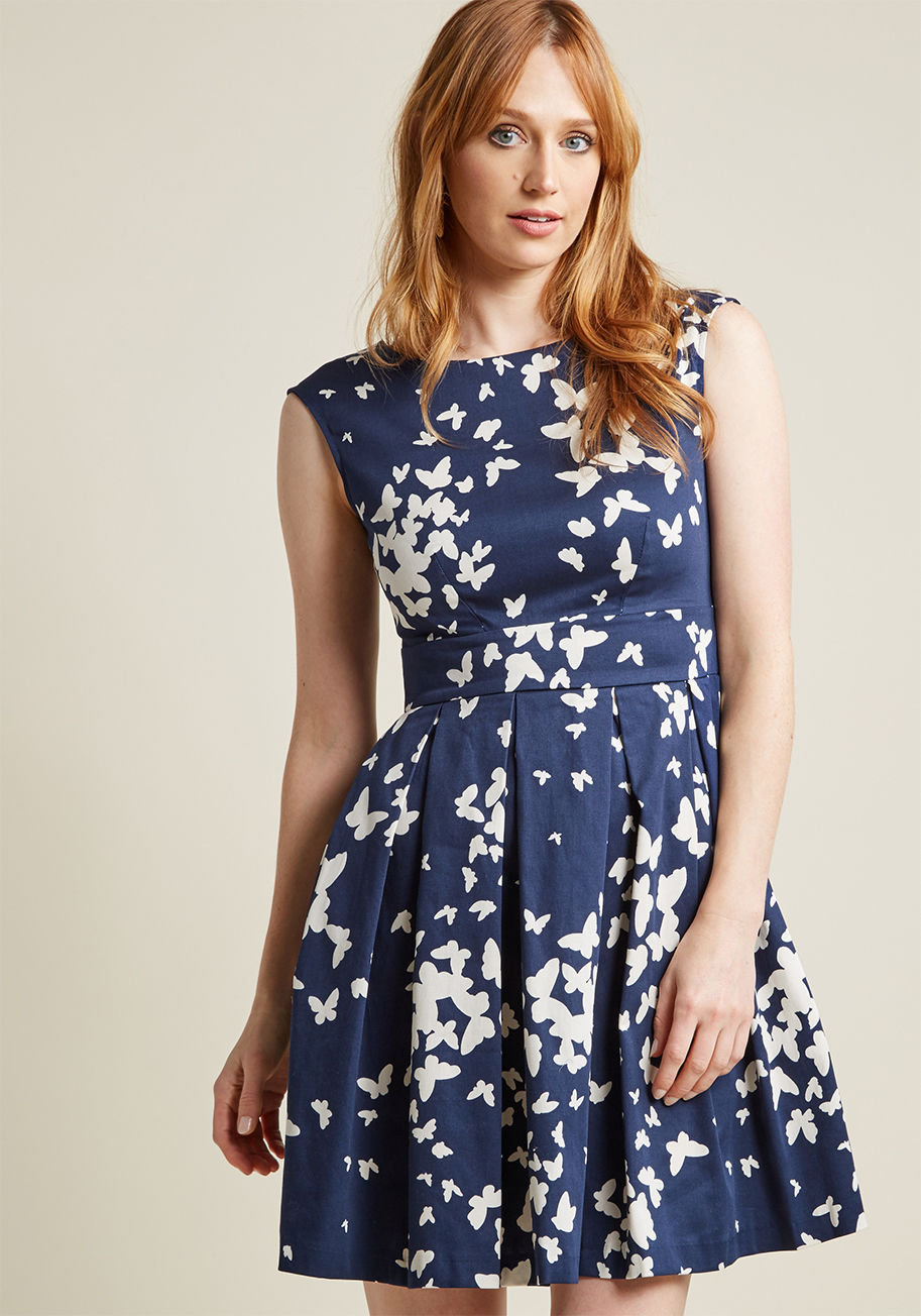 D1237 - Ah, that familiar pitter-patter of the heart you feel after slipping into this butterfly-print frock by Closet London! With a bow-adorned back and a playful, pleated skirt, this navy-blue and white A-line makes you fall