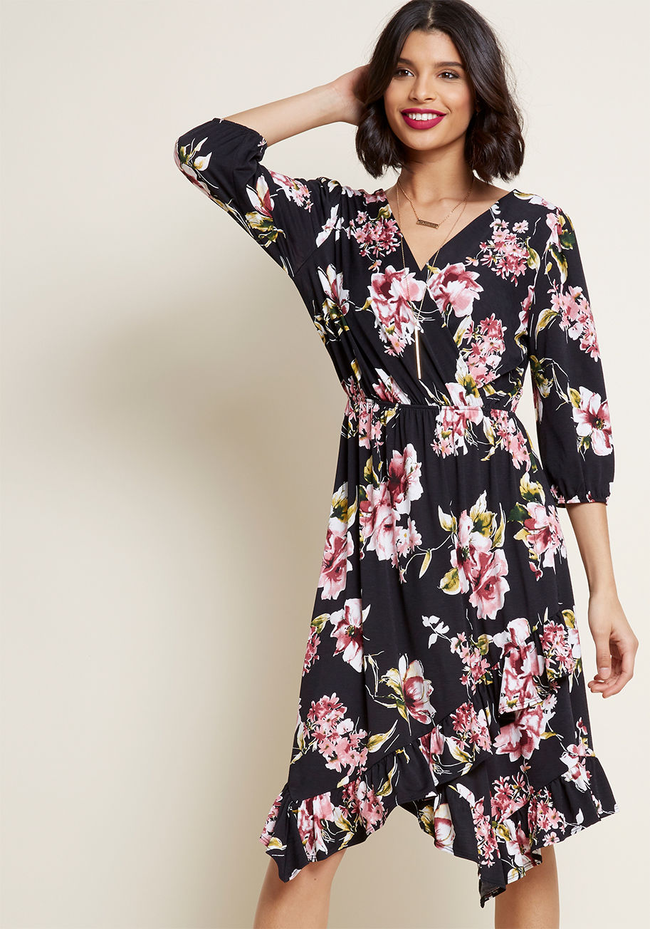 D13342 - Isn't it amazing how a black midi dress can change everything about your wardrobe? This particular frock features a romantic surplice neckline, an asymmetrical hemline ruffle, and stretch at the 3/4 sleeve cuffs and waist. From the office to a starlit dat