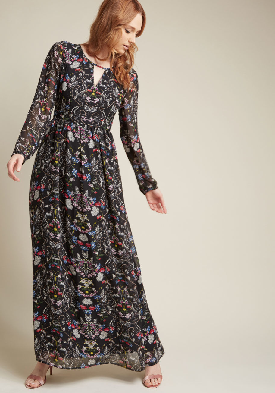 D61593 - Feeling ethereal? After you slip into this black maxi dress, you certainly will! A ModCloth exclusive, this otherworldly ensemble features a keyhole neckline, sheer long sleeves, subtle waistline pleats, and a floral print, all of which will transport you