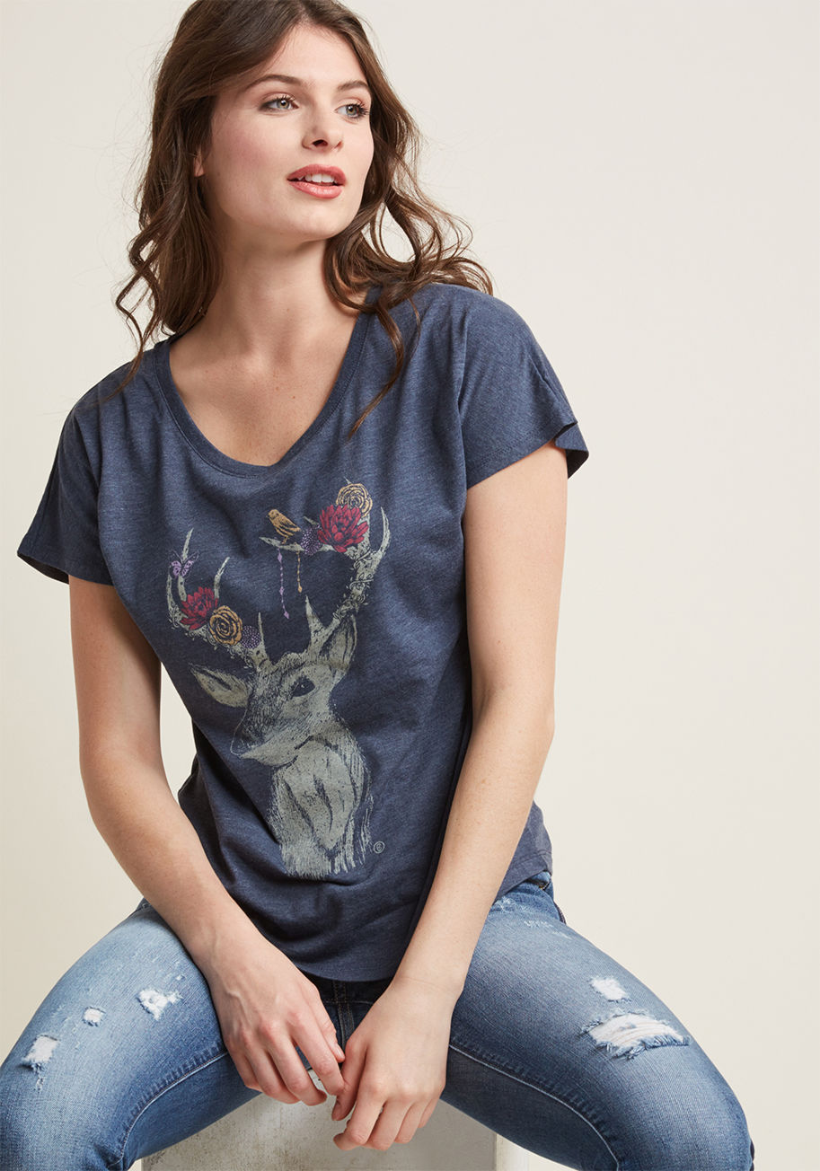 D6867 - If the question is how to bring some whimsy to a time-tested get-up, you'll reply with this blue graphic tee! Screen printed with a darling deer adorned with colorful flowers, beads, and wildlife, this slub-fit top is the solution to your unexpected outfi