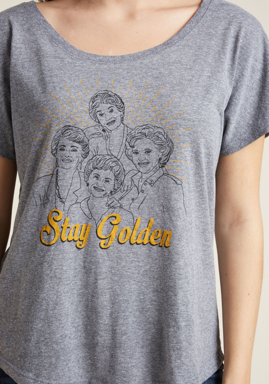 D7005 - Are you a Dorothy, a Rose, a Blanche, or a Sophia? Slip into this heather grey graphic T-shirt and sit down with your gal pals to pick your golden role models! Sporting dolman short sleeves, a wide neckline, and a black-and-goldenrod screen print, this tr