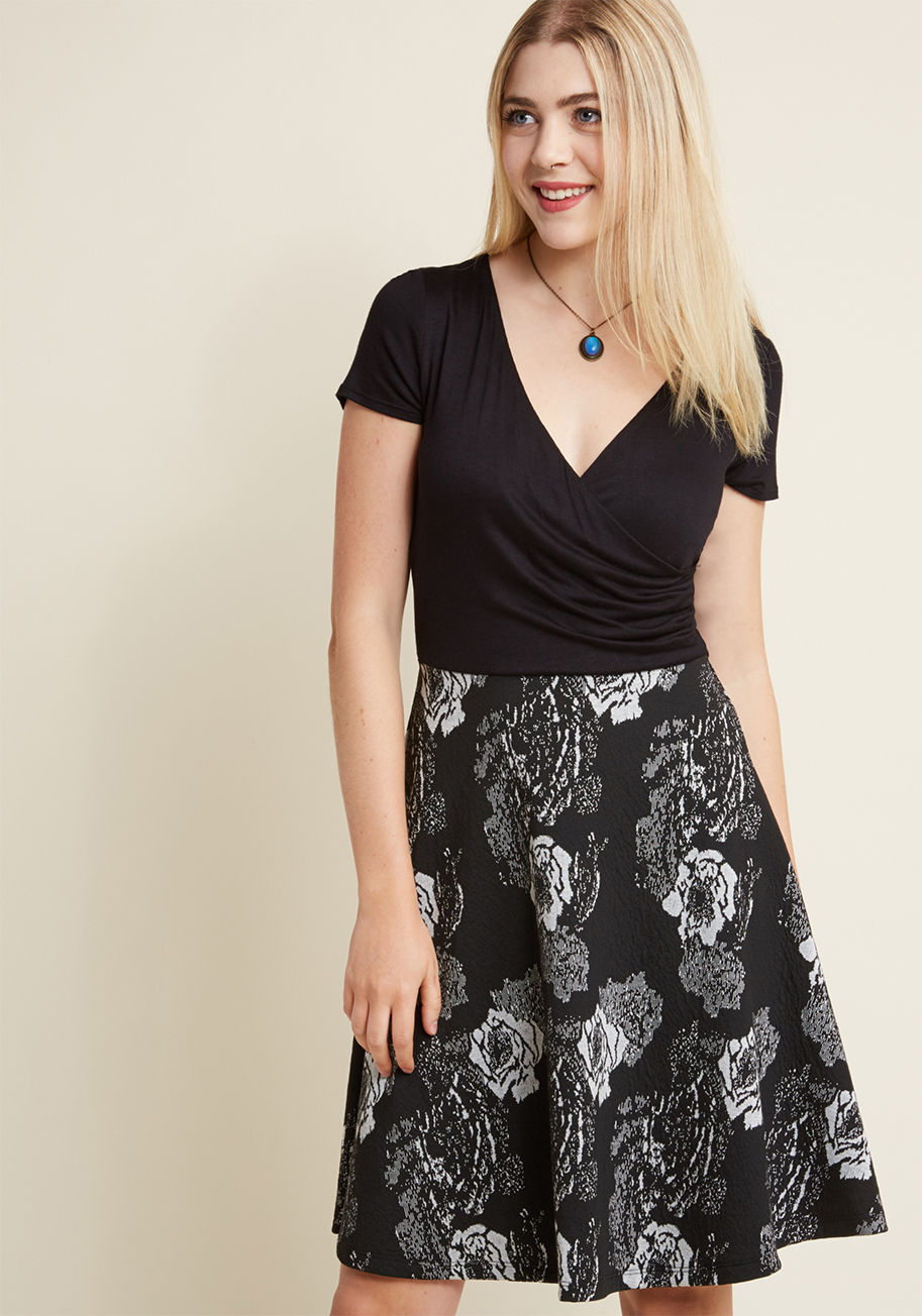 D7453H - Whether you decide on peach oatmeal or waffles at the garden&rsquo;s cafe, you already made a stylish choice with this black dress. Boasting a flirty wrap top and a textured skirt with dreamy grey flowers, this ModCloth-exclusive frock is as beautiful as 