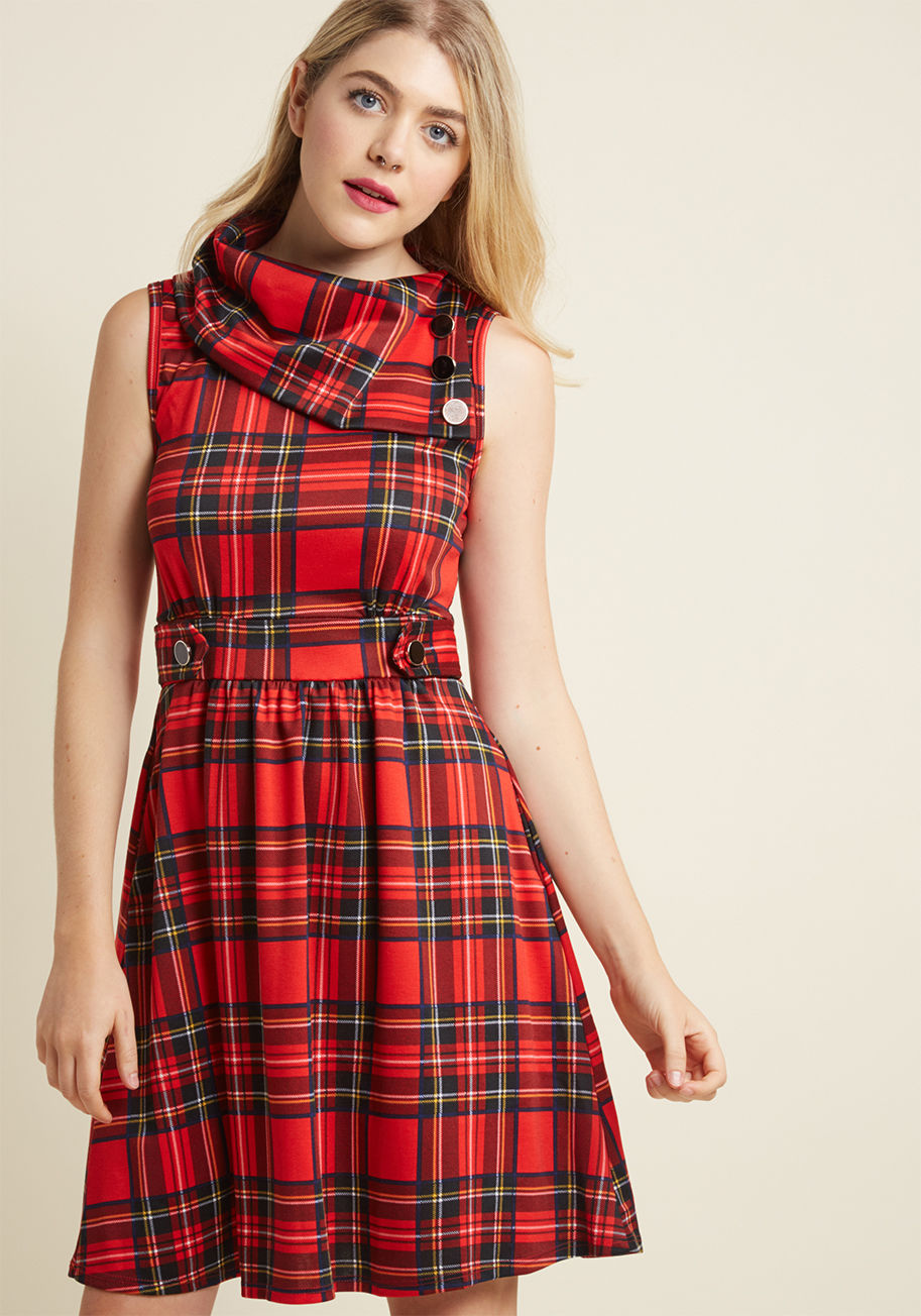 D9821 - This red, white, and black plaid dress is so magical, it makes you long for somewhere special and new to wear it. Take the foldover collar, embellished waistband, and decorative buttons of this knit ModCloth exclusive on a scenic getaway to actualize your