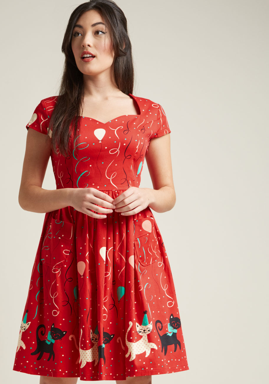 DR5351 - You may want to take a seat before the fiesta motif of this Banned midi dress sweeps you right off your feet! Cap sleeves frame the retro neckline of this stretch-cotton number, while sleek princess seams, hidden pockets, and a print of balloons and celeb