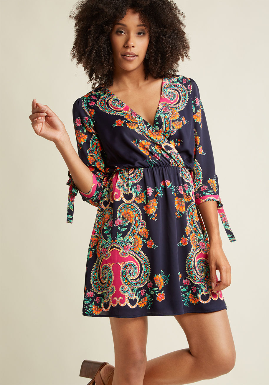 DR8293 - This navy wrap dress is more than just a bold look - it's a resource for others to instantly identify that you're one confident gal! Jazzing up the surplice neckline, knotted 3/4-sleeves, and mini skirt of this woven beauty is a breathtaking paisley print