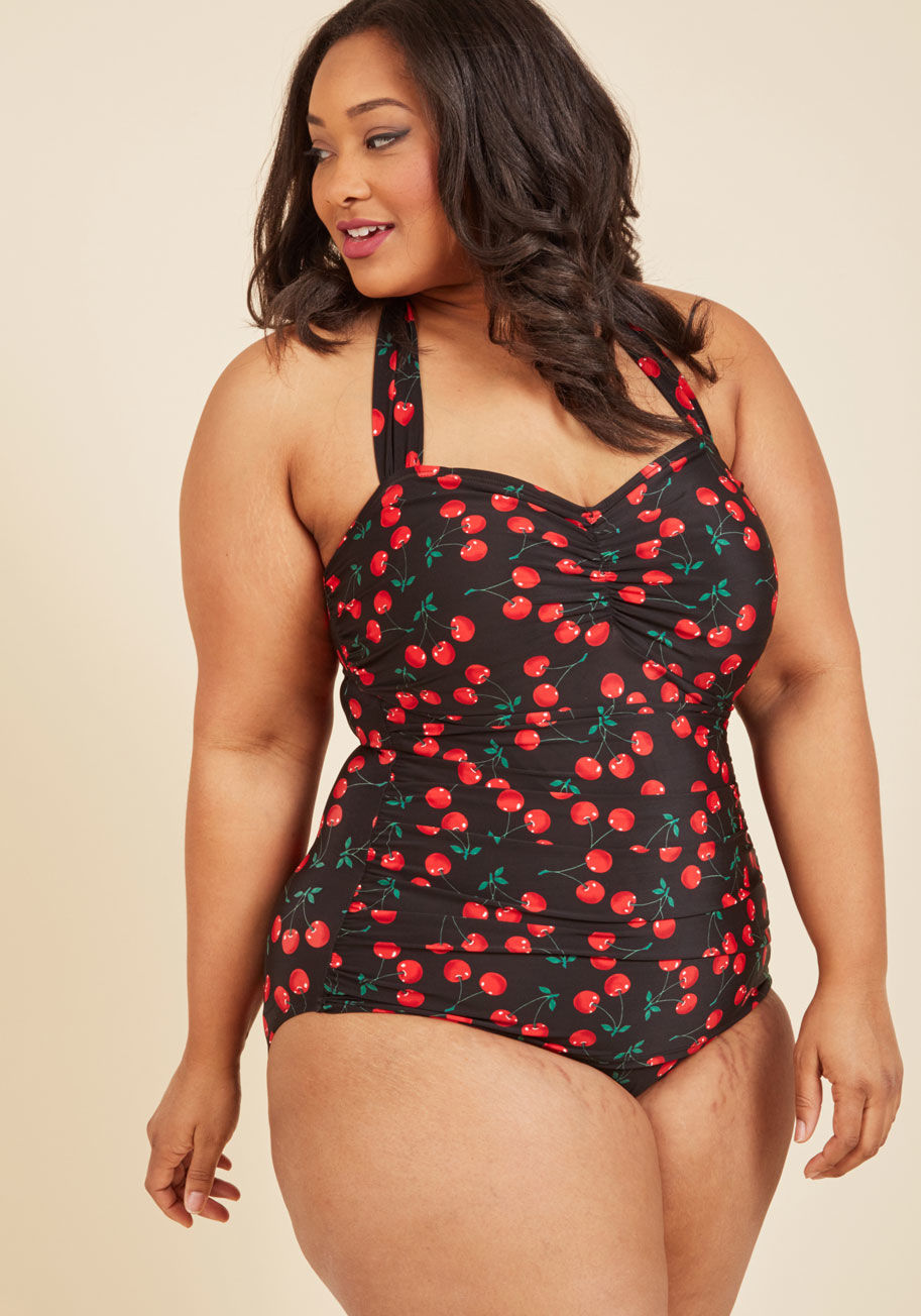 E11014 - Make your seaside afternoon maraschino chic by tying the scarlet-and-noir strings of this Esther Williams bathing suit behind your neck! The halter top, comfortable bust padding, side ruching, and low-cut legs of this swimsuit are all aspects of her desig