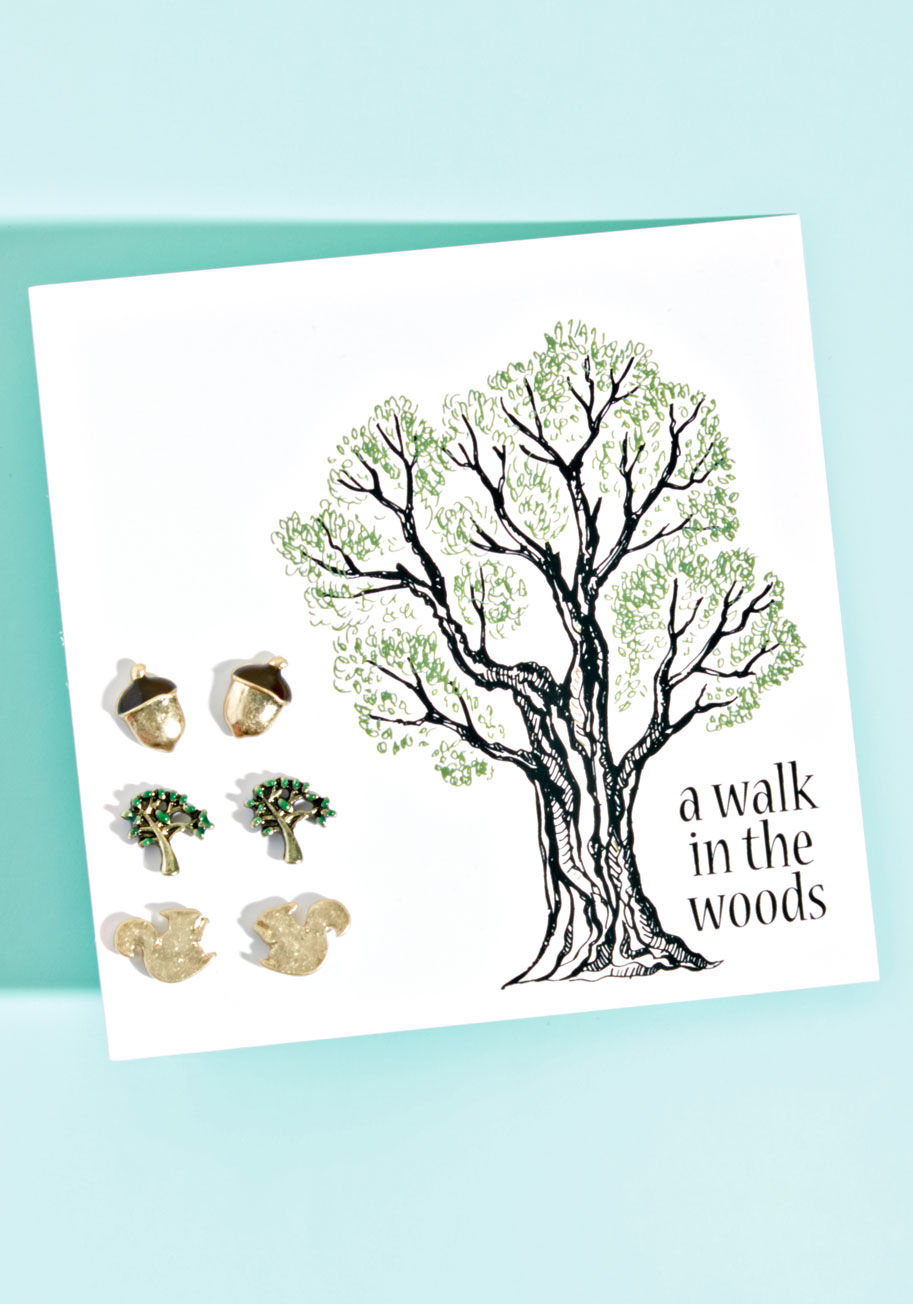 E5422 - Even on the days you have to spend indoors, you can channel the winsomeness of the wilderness with this earring set! Atop the surgical steel posts of this stud trio, you'll find acorns, trees, and squirrels, shining with a gold hue that's perfect for mixi