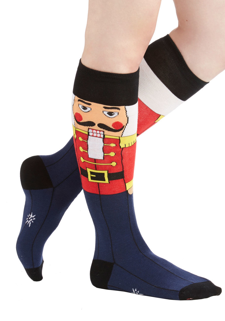 F0176 - Celebrate the winter holidays with especially festive flair while sporting these seasonal nutcracker knee socks! These intarsia-knit socks feature the classic yuletide image of a mustachioed nutcracker