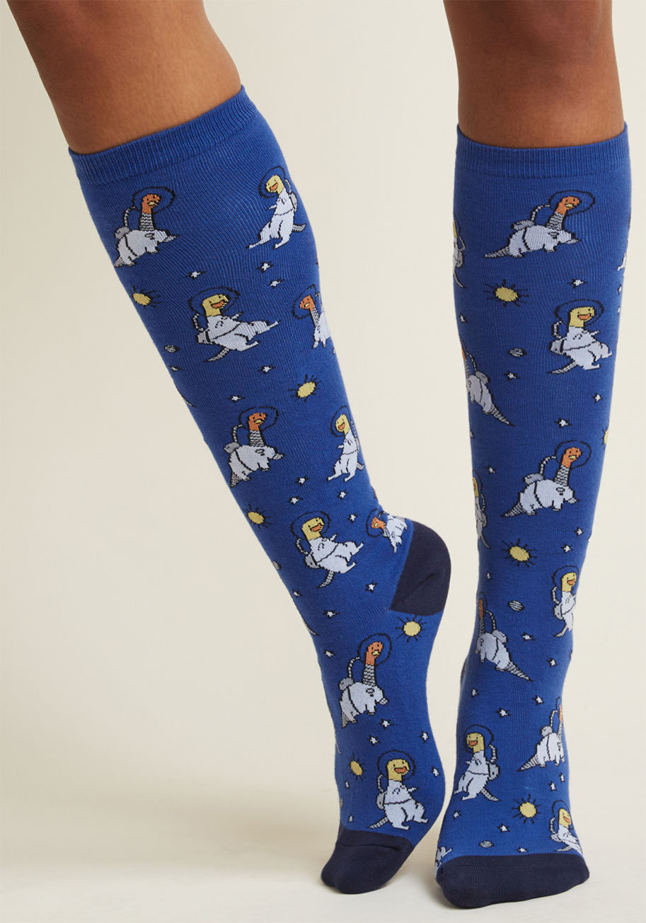 F0338 - In space, no one can hear you roar. Luckily, your yelps of glee from wearing these dinosaur knee socks will be just as audible as you are earth-bound! Decked out