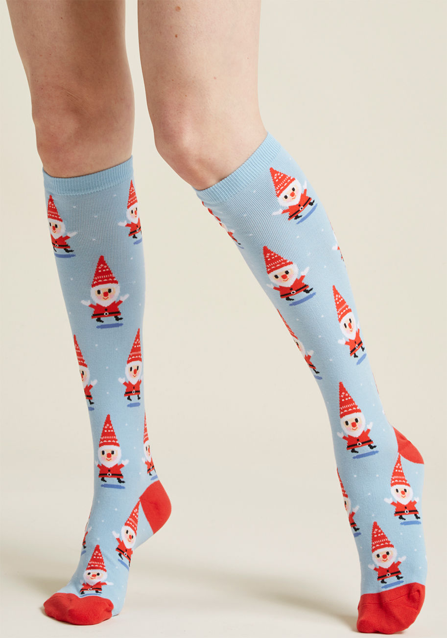 F0365 - Celebrate the season of cheer from the tip of your pointed hat to the toes of these pale blue socks! Decorated with bright trim and gleeful gnomes disguised as tiny Santas, these quirky knee-highs will fill each step of your holiday season with impish del