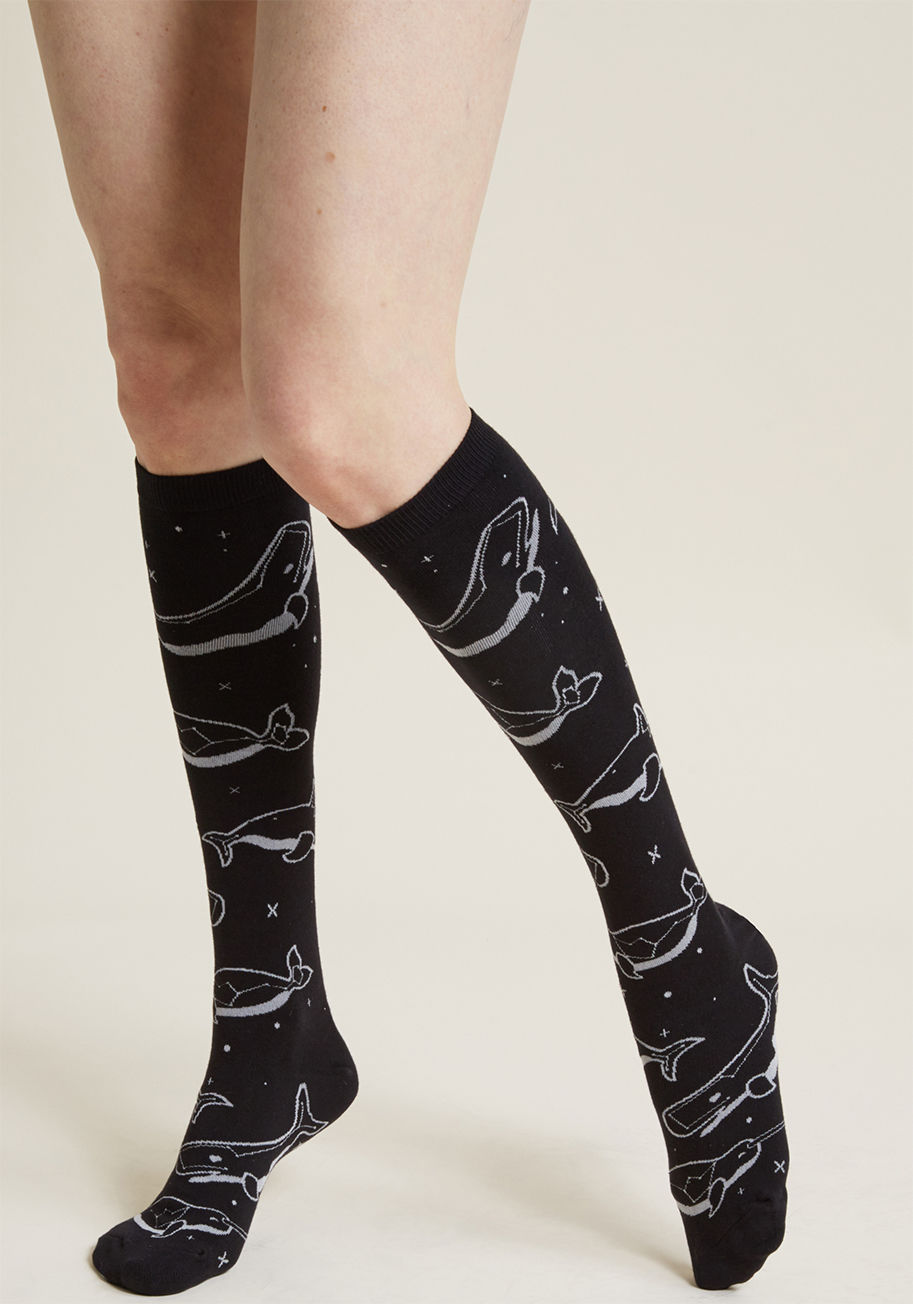 F0368 - 'Whale' looky here - these black socks are a true treat for your inner oceanographer and astronomer! A pod formed from heavenly bodies imbues these knee highs with all the coolness and character you could ever desire. No need to wish upon a star for quirk