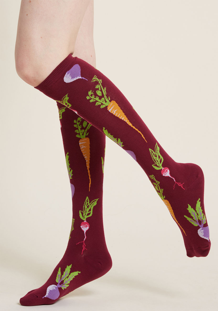 F0410 - Get right to the 'root' of quirky hosiery by harvesting these fuchsia socks and adding 'em to your collection! Patterned with turnips, carrots, and radishes aplenty, these flavorful knee highs provide your daily recommended serving of unexpected style.