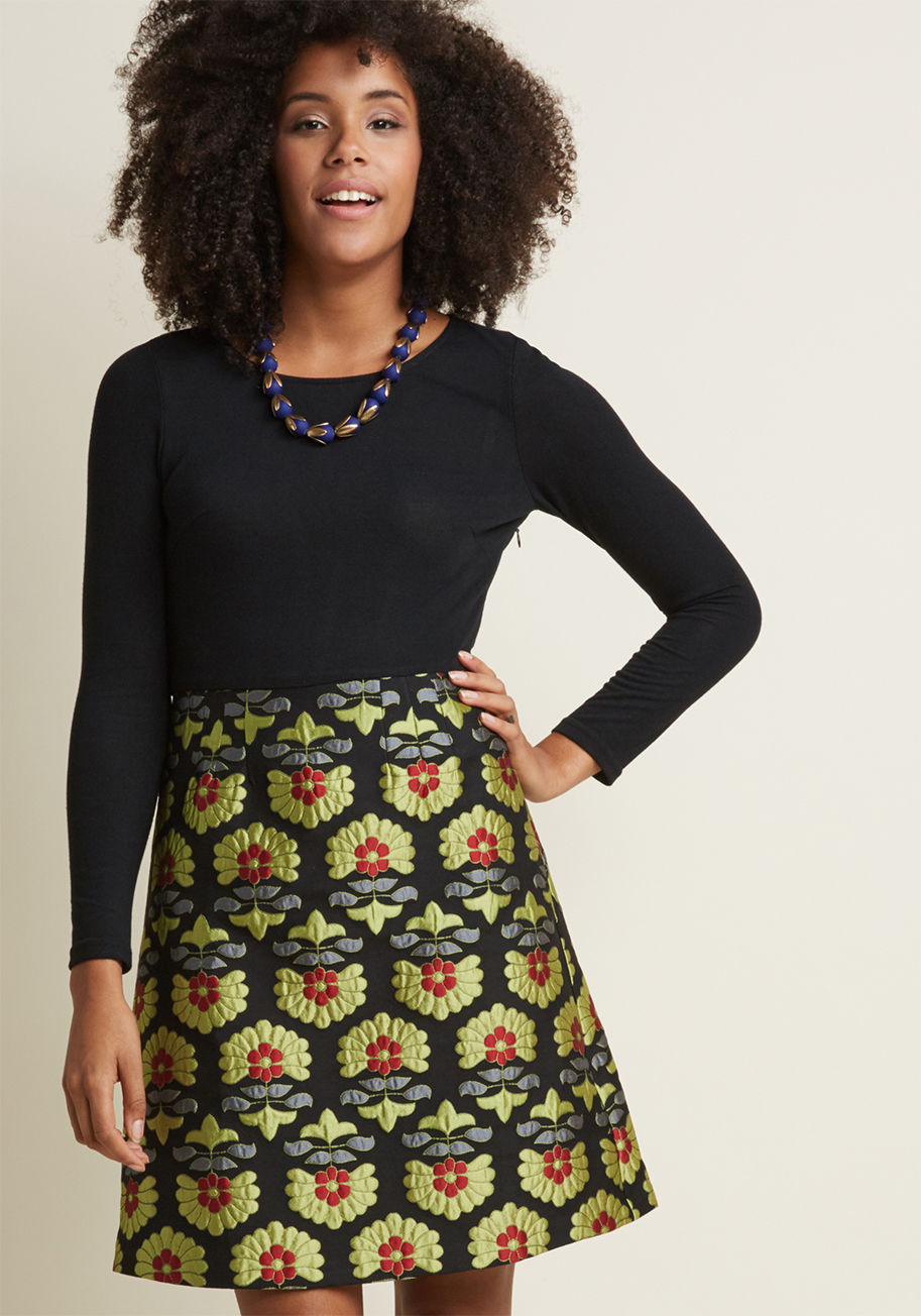 F0F10189 - Put your most fabulous foot forward by flaunting this fancy twofer dress! Its black, knit bodice boasts lovely long sleeves, while its jacquard skirt glows with chartreuse, grey, and red flowers. Inviting abundance is one great feature you and this frock 