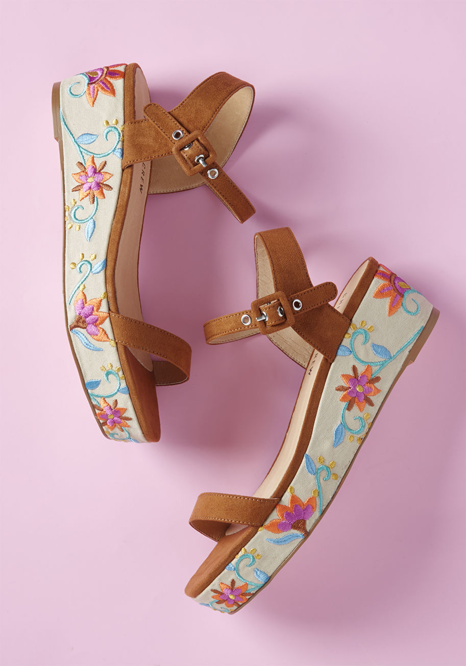 Friday - Reign supreme over the realm of fabulous footwear from the allure of these platform sandals from Chelsea Crew! Supported by brown faux-suede straps, lined with luxurious leather, and stitched with brilliant flowers from toe to heel, these kicks crown you 