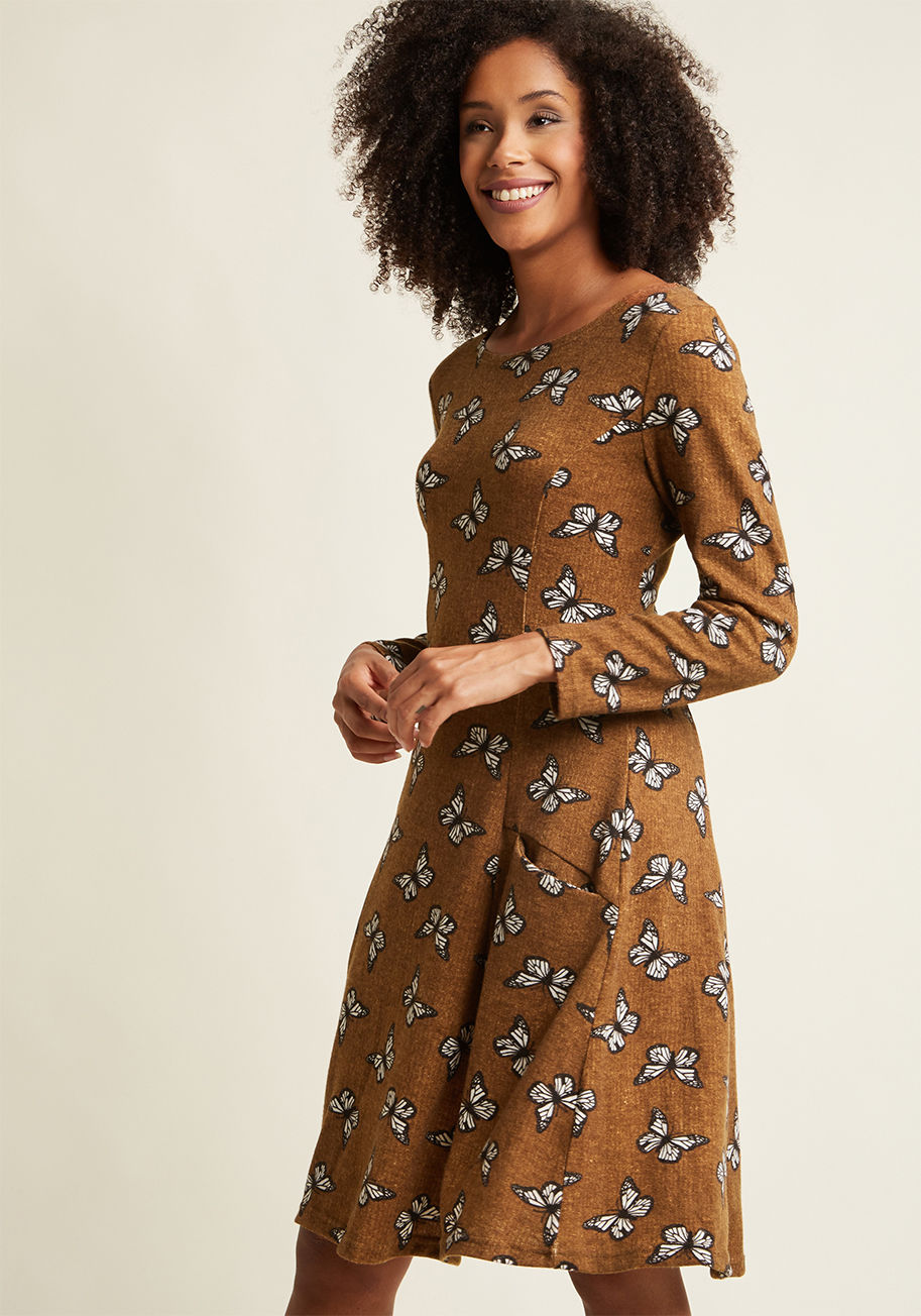 FS17207 - Not every garment is tailored to make you feel like your best - most winning - self, but this pocketed sweater dress sure is! Style its brown knit, black-and-white butterfly print, and princess seams, so that your sweetest side is undeniably detectable. Y