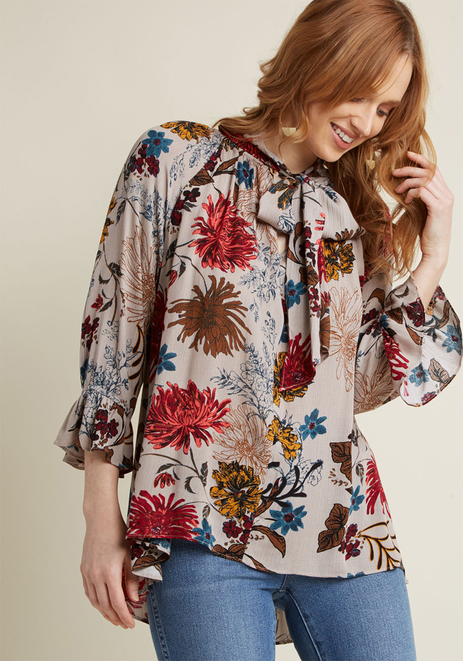 FT88408 - Once the breezy silhouette and ethereal details of this floral top set you adrift, you'll be calling out for others to join you on a fashionable float. If the tied neckline atop a V-neckline, subtle trumpet sleeves, and boho-inspired vibe of this taupe bl