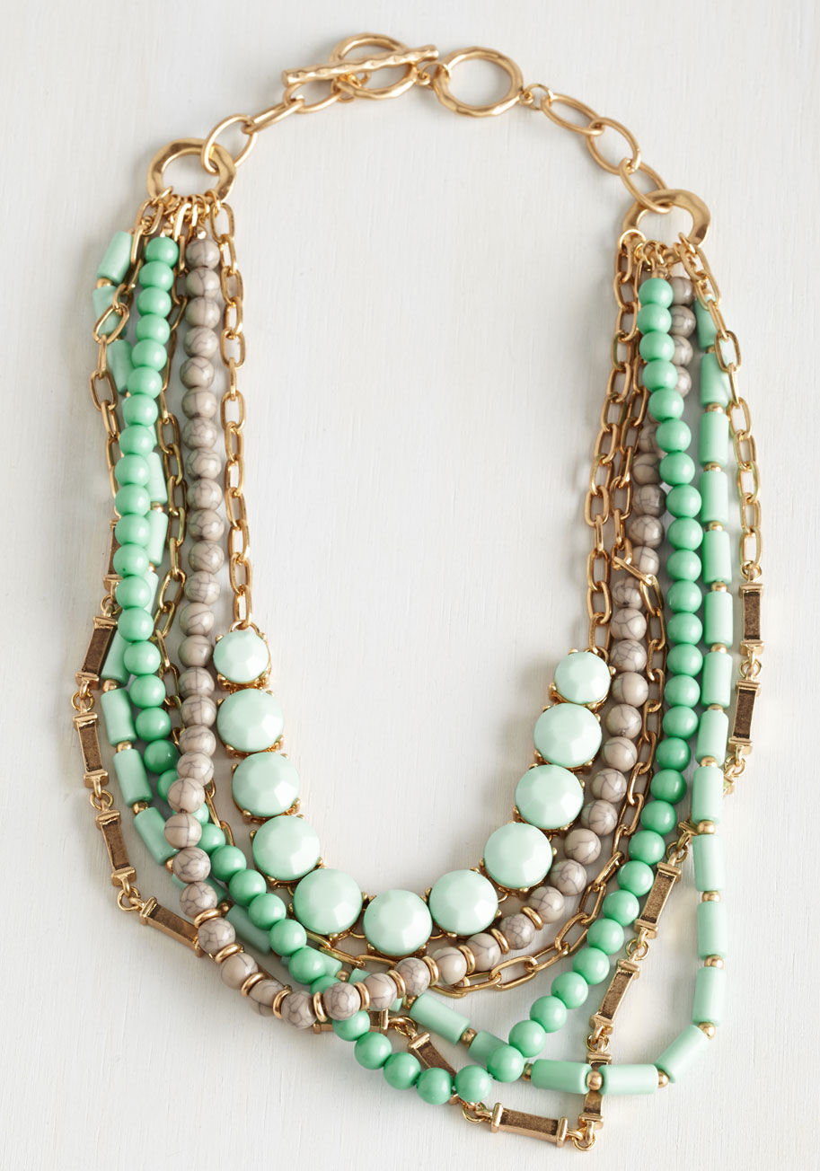 IN1907 - Wondering if you can sport this statement necklace with that look? The answer is always, &ldquo;Yes!&rdquo; Layer this accessory over any ensemble to flaunt its layered strands of faux-pearls, grey beads, golden chains, and seafoam stones - eliciting ooh 