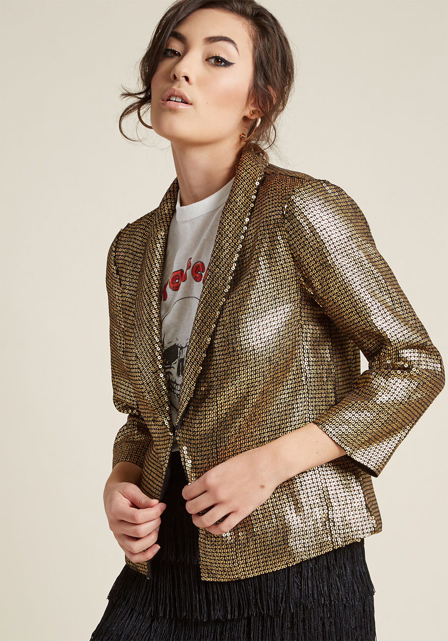 JK-1199 - If you're not the type to shy away from shine, then get acquainted with this sequin blazer! A ModCloth exclusive, this gold stunner elevates casual pieces and matches intricate ones with its rounded lapels, open front, silky lining, and assuring attitude.