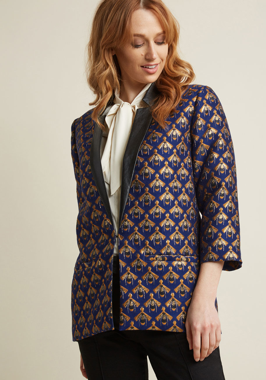 JK31114 - Make your ensemble the talk of the city block by adding this royal blue blazer to your getup! Featuring a metallic gold and sunflower yellow jacquard fabric sewn