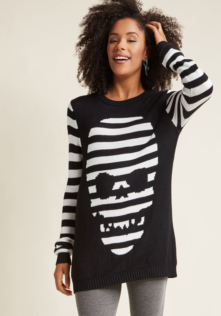 JP1541 - Warning - do not wear this super-soft sweater from Banned unless you desire loads of compliments! With the ability to be worn as either a sweater dress or a long top, this black-and-white striped layer - featuring an intarsia skull design - will have all 