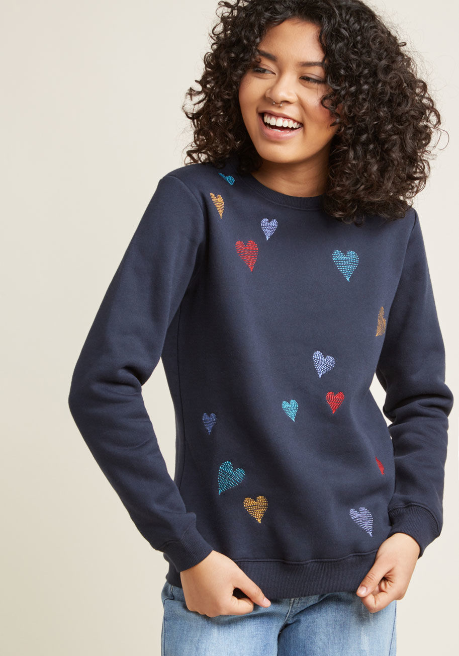 K0062 - Always true to your lighthearted style, you're quick to add this navy blue pullover by Sugarhill Boutique to your collection of casual tops. The scribbled hearts embroidered