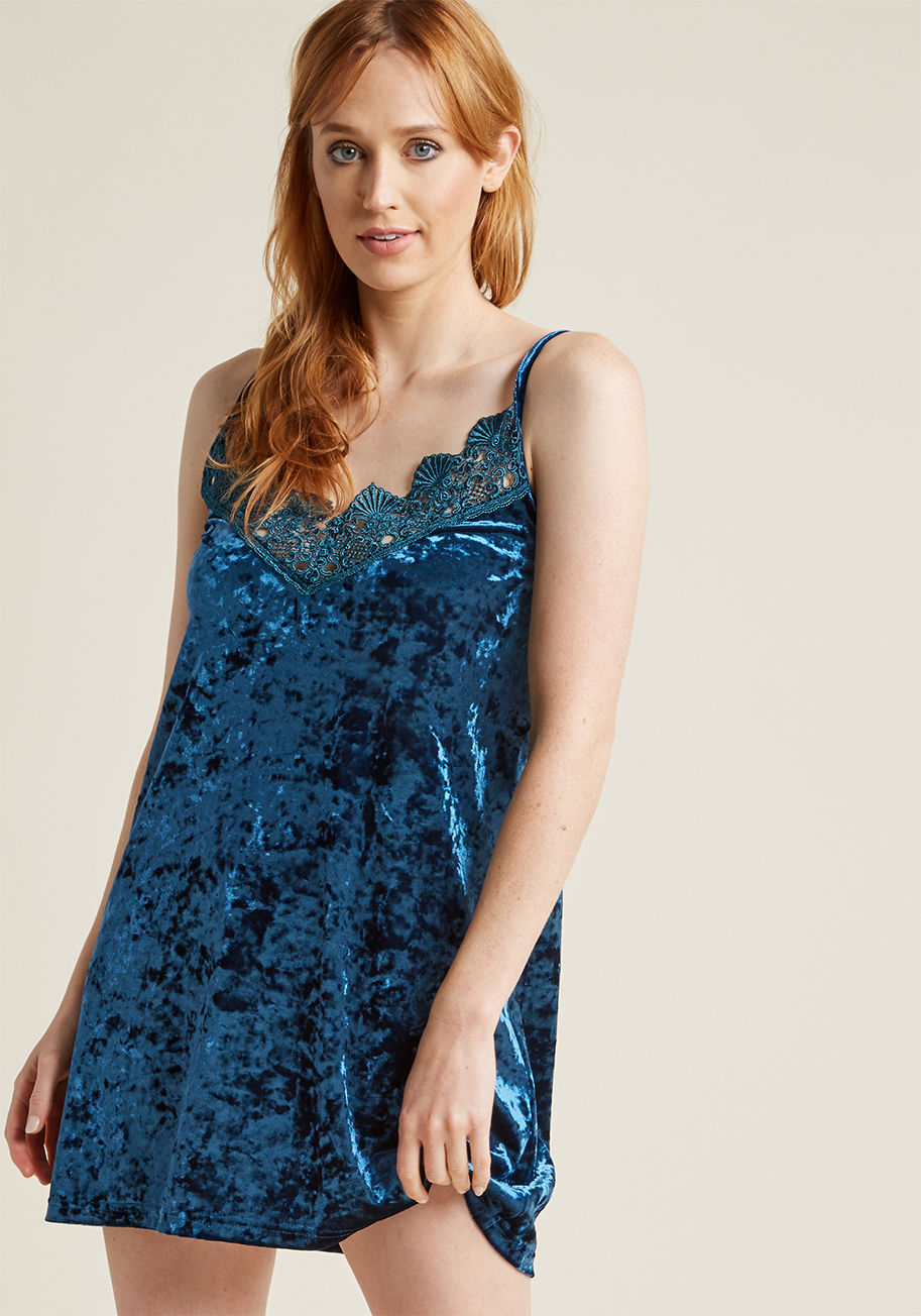 K124 - Gazing at this velvet nightie, you note how its delicate spaghetti straps, ornate lace trim around the neckline, and rich blue hue allude to an evening of enjoyment. You slip the soft fabric of this elegant intimate over your head, letting its loose silho