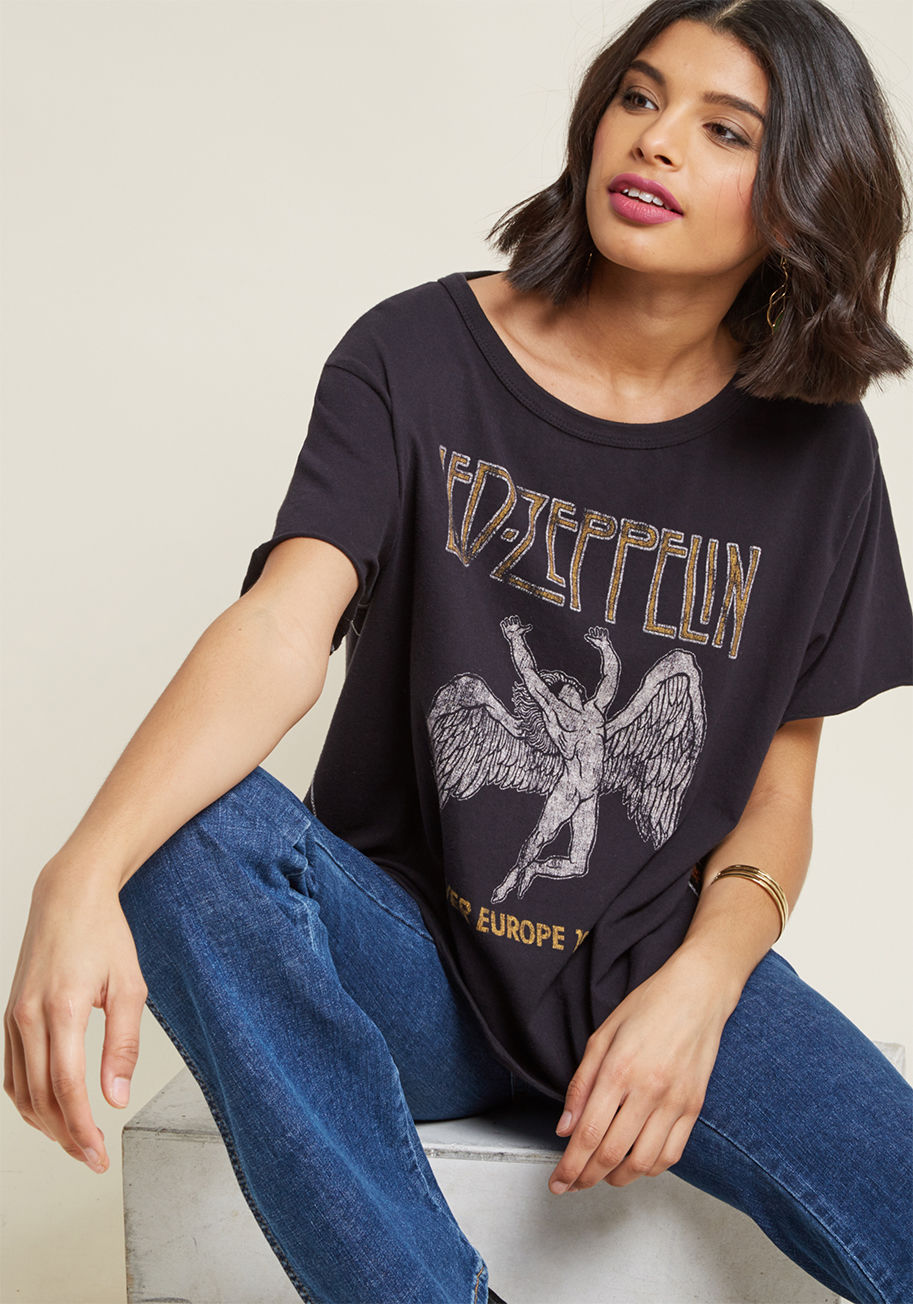 LZ 245 - This black graphic tee commemorates the final concert tour by English rock legends Led Zeppelin with an aesthetic straight from the era! Soft cotton fabric forms the boxy fit of this American-made top from TRUNK LTD., as raw edges at the sleeves, reinforc