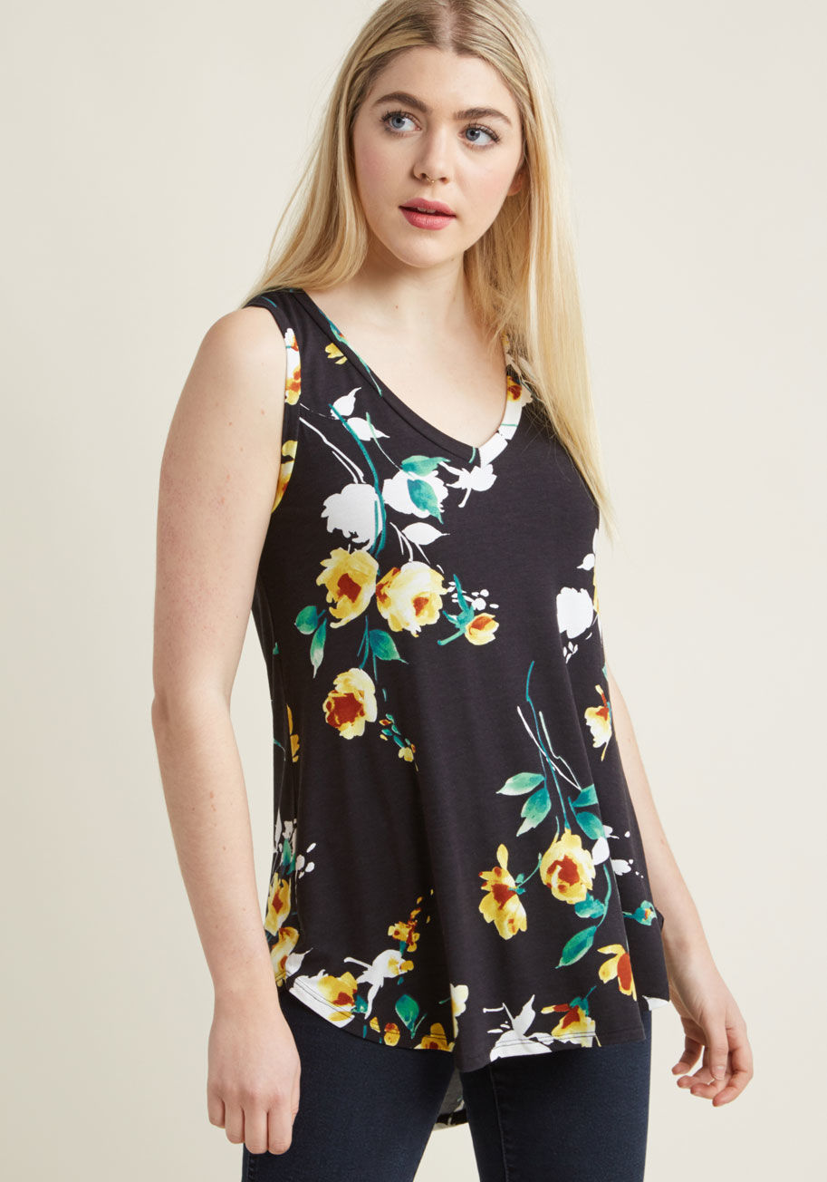 MC-1067 - Every fashionista knows the necessity of pieces that can be infinitely styled, and this black top promises unlimited options. This V-neck's high-low hem and ultra-soft jersey knit pair with a dreamy, watercolor floral pattern to assure boundless outfittin