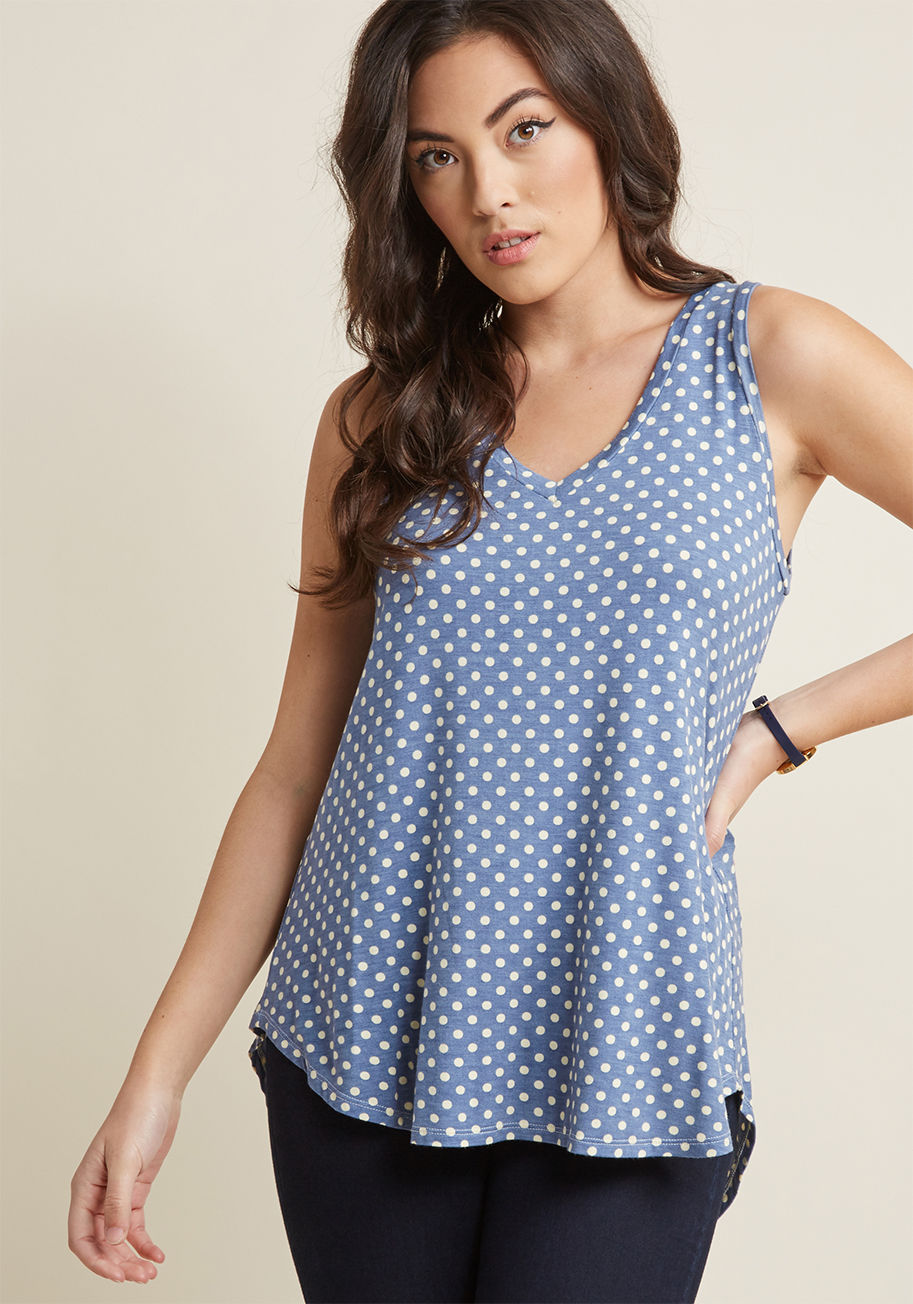 MC-1068 - Every fashionista knows the necessity of pieces that can be infinitely styled, and this dotted top promises unlimited options. This V-neck's high-low hem and ultra-soft jersey knit pair with a cornflower blue hue to assure boundless outfitting potential.