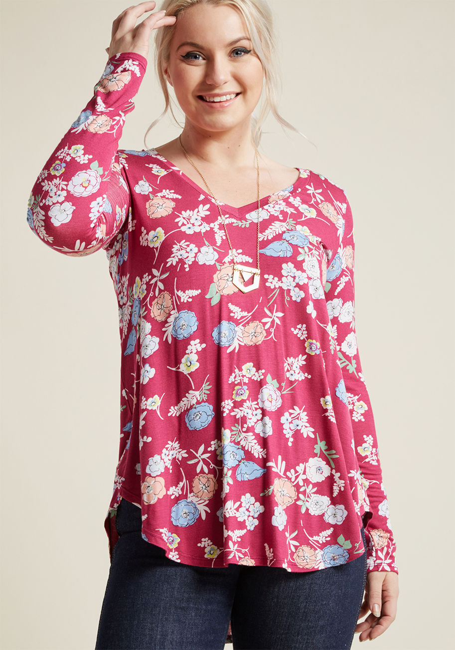 MC-1071 - Layer it on or let it stand alone as the star of your outfit - however you style this fuchsia floral tunic, you're bound to look adorable! With a V-neck, a soft jersey knit, and a curved high-low hemline, this long-sleeved top takes the cake as cutest sta