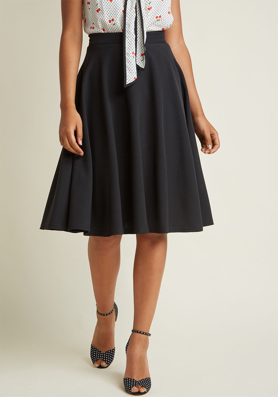 MC73560 - You hear your friend&rsquo;s truck horn toot outside your window - your trumpet call to scoot this A-line skirt out the door and hop in! Back-zipped and buttoned, and boasting a high waistline, this classic black bottom looks blissful against every panora